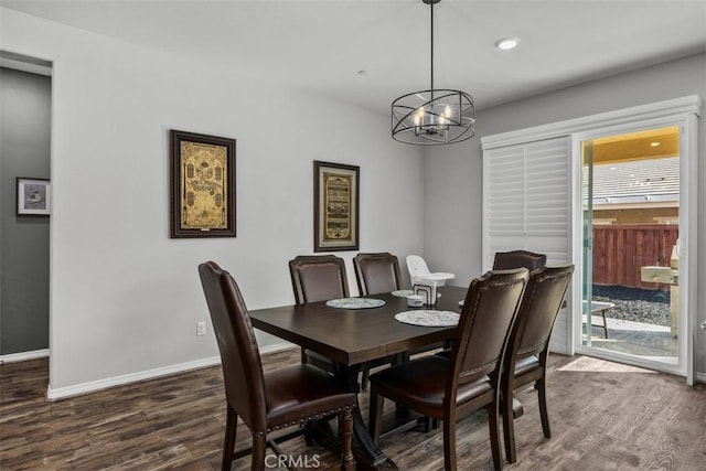 dining room with dark wood-style flooring, a chandelier, baseboards, and recessed lighting