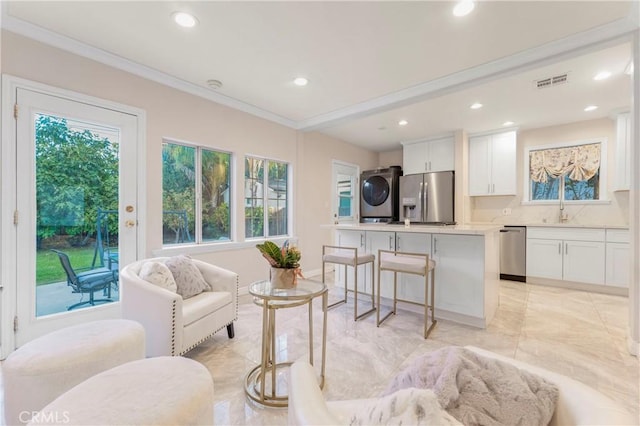 19119 Lemay St, Reseda, CA 91335 - living area featuring stacked washer and clothes dryer, recessed lighting, light marble finish flooring, and ornamental molding