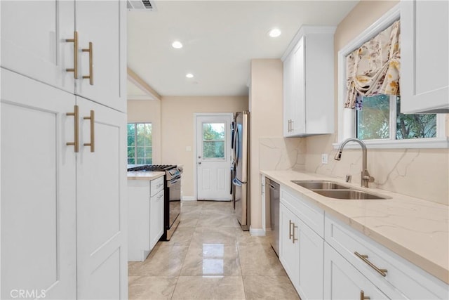 19119 Lemay St, Reseda, CA 91335 - kitchen with a sink, stainless steel appliances, white cabinets, light stone counters, and recessed lighting