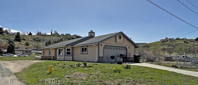 14402 Boxtree St, Lake Hughes, CA 93532 - view of home's exterior with an attached garage, driveway, a chimney, and a mountain view