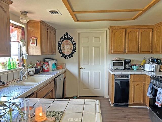 14402 Boxtree St, Lake Hughes, CA 93532 - kitchen with tile countertops, a sink, stainless steel appliances, and dark wood-style floors