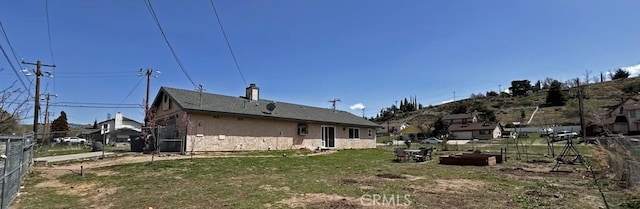 14402 Boxtree St, Lake Hughes, CA 93532 - rear view of house with stone siding and a chimney