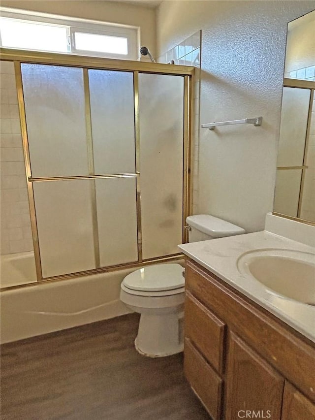 14402 Boxtree St, Lake Hughes, CA 93532 - bathroom with vanity, wood finished floors, and bath / shower combo with glass door