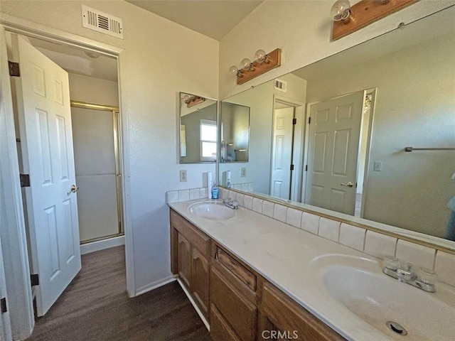 14402 Boxtree St, Lake Hughes, CA 93532 - bathroom with double vanity, wood finished floors, and a shower stall