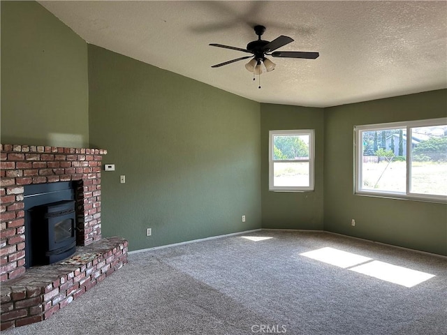 14402 Boxtree St, Lake Hughes, CA 93532 - unfurnished living room with carpet flooring, a wood stove, ceiling fan, and a textured ceiling