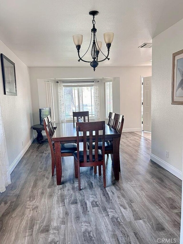 16045 Jackson Dr, Fontana, CA 92336 - dining room with a chandelier, baseboards, wood finished floors, and a textured ceiling