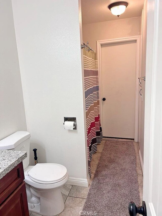 16045 Jackson Dr, Fontana, CA 92336 - bathroom with toilet, tile patterned floors, vanity, a shower with curtain, and baseboards