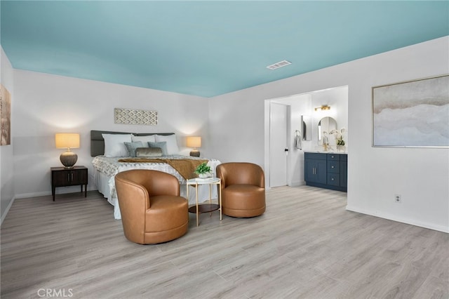24071 Orange Creek Cir, Moreno Valley, CA 92557 - bedroom with light wood-style flooring, baseboards, and connected bathroom