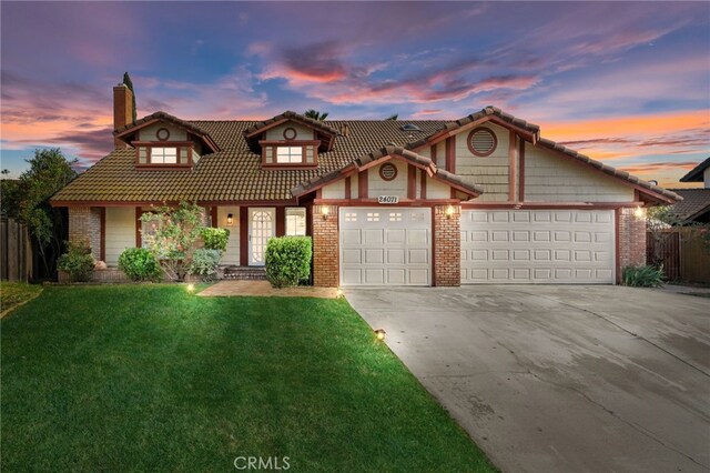 24071 Orange Creek Cir, Moreno Valley, CA 92557 - view of front of home with brick siding, a garage, a chimney, and concrete driveway