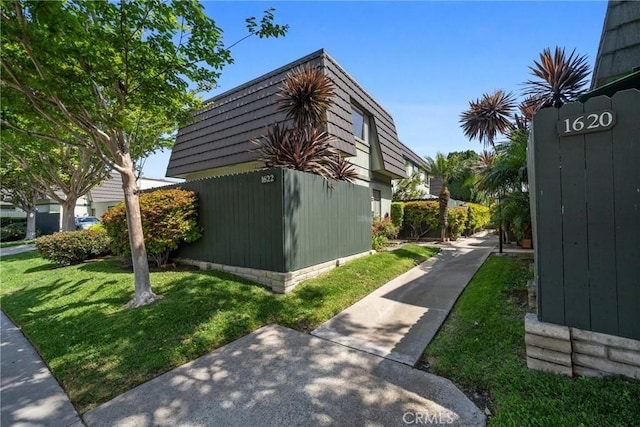 1622 Iowa St Unit A, Costa Mesa, CA 92626 - view of home's exterior with a yard and mansard roof