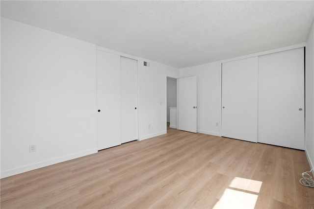 1622 Iowa St Unit A, Costa Mesa, CA 92626 - unfurnished bedroom with two closets, light wood-type flooring, and baseboards