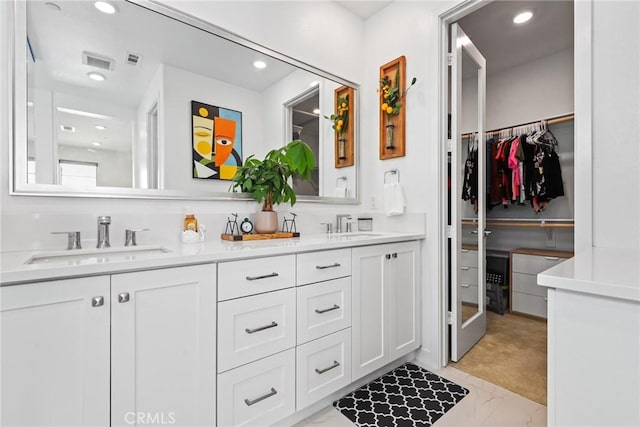 27120 Purple Sage Ct, Valencia, CA 91381 - full bath featuring double vanity, marble look tiles, recessed lighting, and a spacious closet
