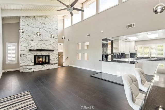 2819 Steeplechase Ln, Diamond Bar, CA 91765 - living area with a ceiling fan, baseboards, high vaulted ceiling, a fireplace, and beam ceiling
