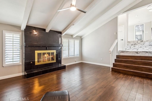 2819 Steeplechase Ln, Diamond Bar, CA 91765 - unfurnished living room with a tiled fireplace, hardwood / wood-style floors, a ceiling fan, baseboards, and stairway