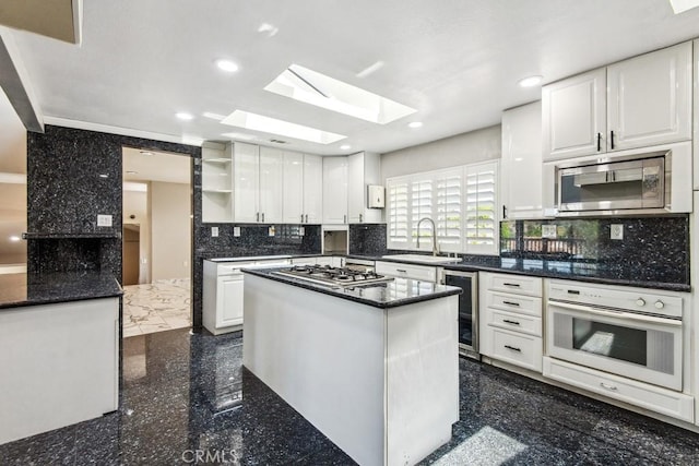 2819 Steeplechase Ln, Diamond Bar, CA 91765 - kitchen with appliances with stainless steel finishes, wine cooler, a skylight, open shelves, and white cabinets