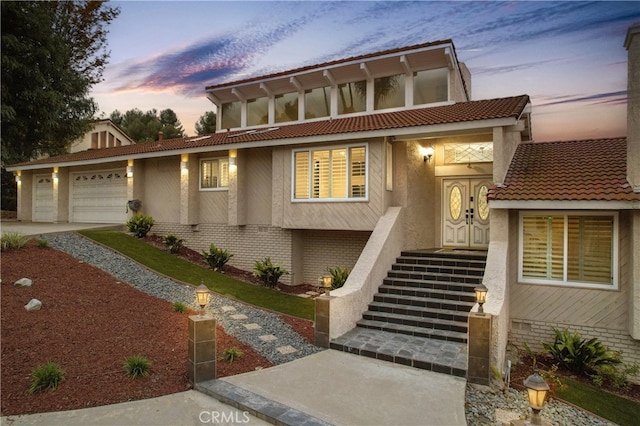 2819 Steeplechase Ln, Diamond Bar, CA 91765 - view of front of house with an attached garage, driveway, stucco siding, and a tile roof