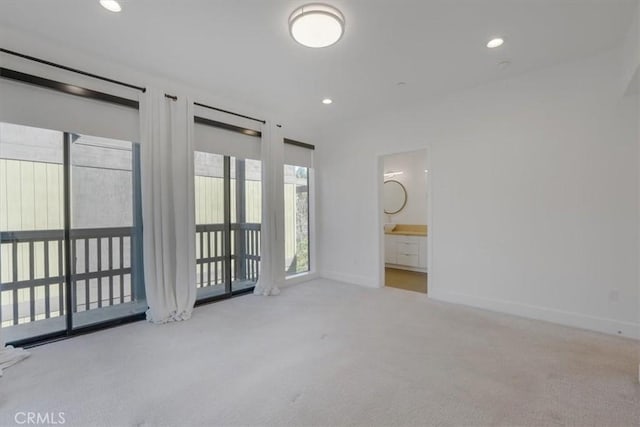 unfurnished bedroom with carpet flooring, baseboards, recessed lighting, and ensuite bathroom