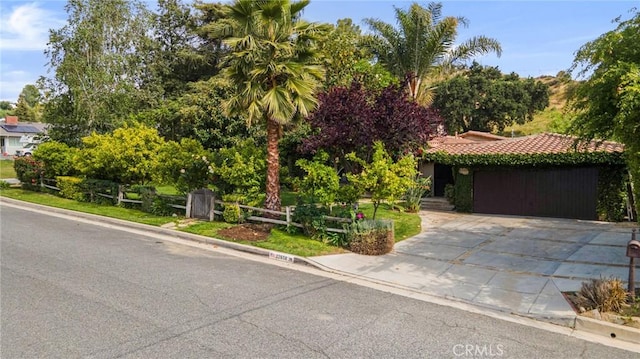 22658 Arriba Dr, Saugus, CA 91350 - obstructed view of property featuring driveway, a tiled roof, and an attached garage