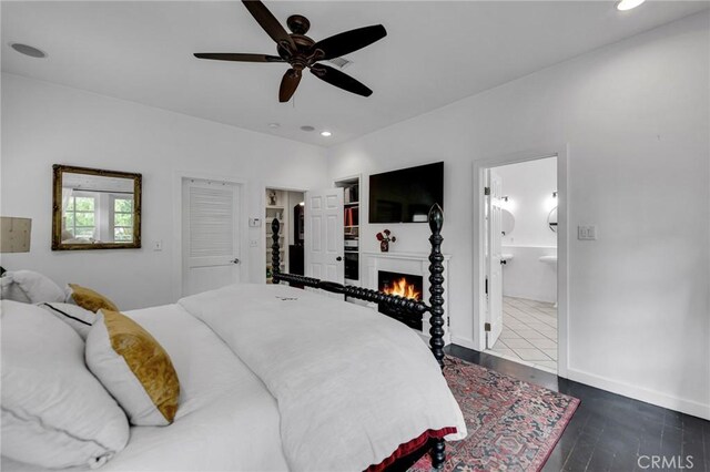 22658 Arriba Dr, Saugus, CA 91350 - bedroom featuring recessed lighting, a lit fireplace, ensuite bathroom, baseboards, and dark wood finished floors