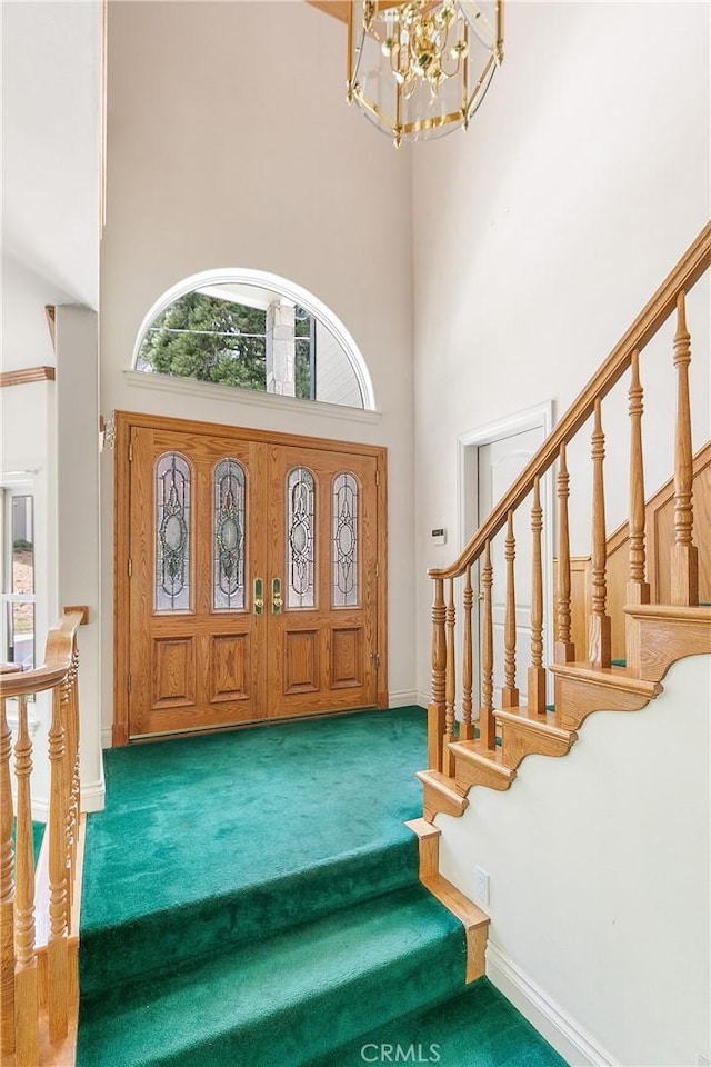 109 S Fairway Dr, Lake Arrowhead, CA 92352 - carpeted entrance foyer with a high ceiling, a chandelier, stairs, and baseboards