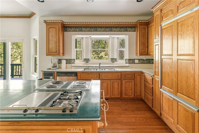 109 S Fairway Dr, Lake Arrowhead, CA 92352 - kitchen with a sink, dishwashing machine, light wood-type flooring, stainless steel gas cooktop, and brown cabinetry