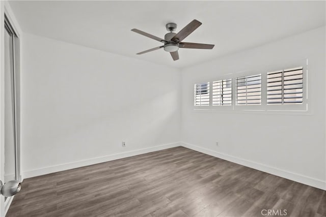 empty room with wood finished floors, baseboards, and ceiling fan