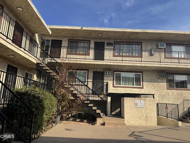 8800 Cedros Ave Unit 210, Panorama City, CA 91402 - view of property featuring stairway and a wall mounted air conditioner