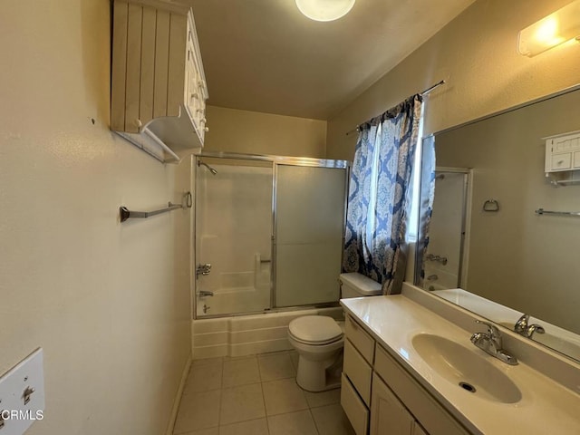 8800 Cedros Ave Unit 210, Panorama City, CA 91402 - bathroom with tile patterned floors, toilet, bath / shower combo with glass door, vanity, and baseboards