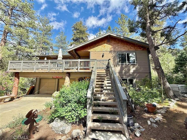 1900 Teton Way, Pine Mountain Club, CA 93222 - rustic home featuring concrete driveway, a deck, stairs, and a garage