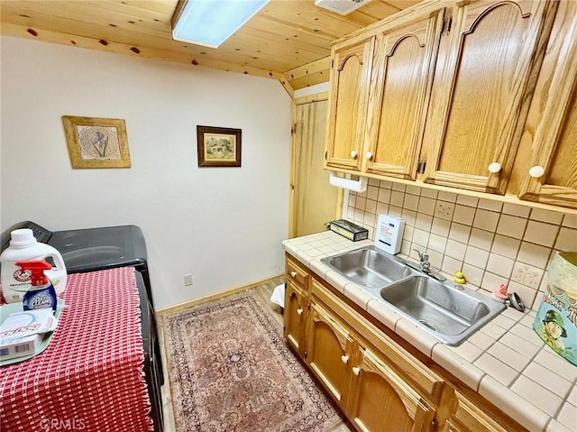 1900 Teton Way, Pine Mountain Club, CA 93222 - kitchen featuring tile countertops, a sink, tasteful backsplash, baseboards, and wooden ceiling