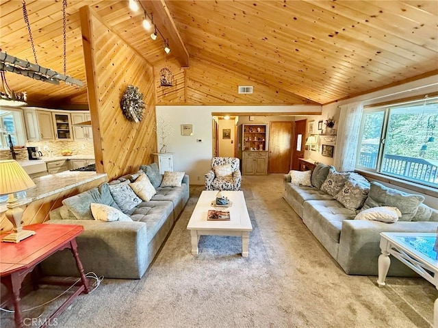 1900 Teton Way, Pine Mountain Club, CA 93222 - living room with a wooden ceiling with exposed beams, rail lighting, light carpet, wood walls, and high vaulted ceiling