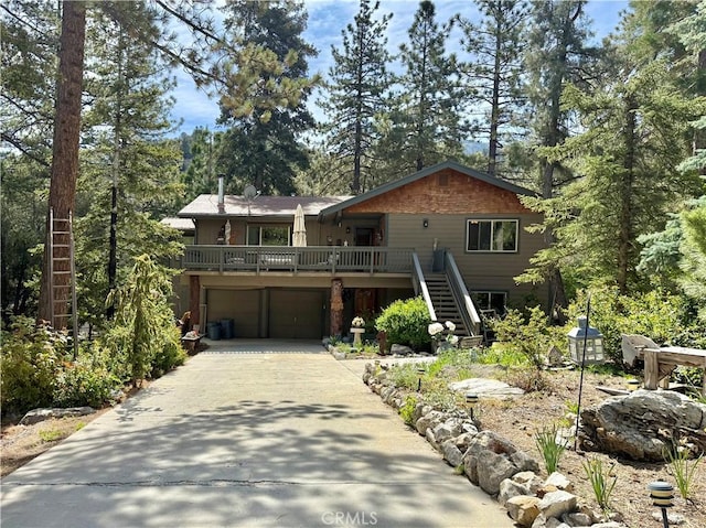 1900 Teton Way, Pine Mountain Club, CA 93222 - chalet / cabin featuring stairway, concrete driveway, an attached garage, and a deck