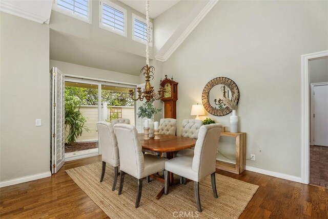 19 Rollins Pl, Laguna Niguel, CA 92677 - dining room featuring high vaulted ceiling, baseboards, a chandelier, and wood finished floors