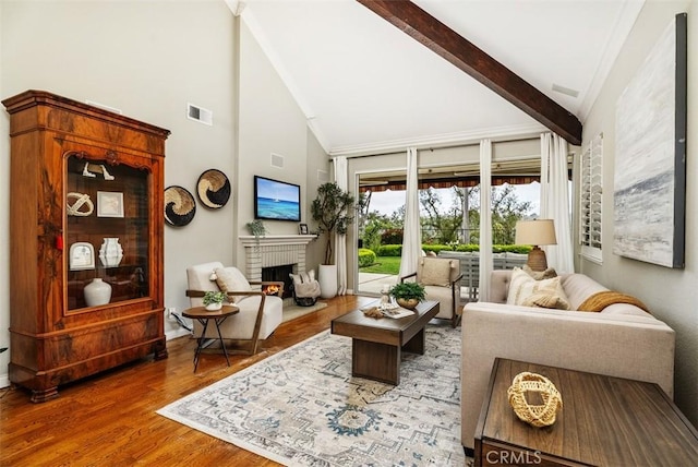 19 Rollins Pl, Laguna Niguel, CA 92677 - living room with high vaulted ceiling, a brick fireplace, wood finished floors, beamed ceiling, and baseboards