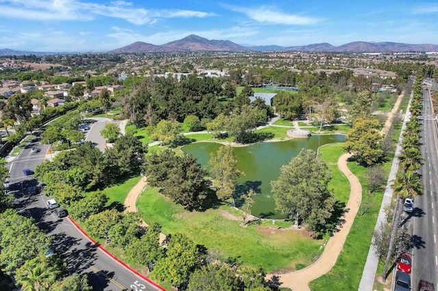 view of property location with a water and mountain view and nearby suburban area