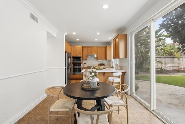 dining area featuring crown molding, light tile patterned floors, recessed lighting, and baseboards