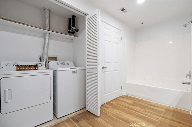 160 S Hudson Ave Unit 202, Pasadena, CA 91101 - washroom with washing machine and dryer and light wood finished floors