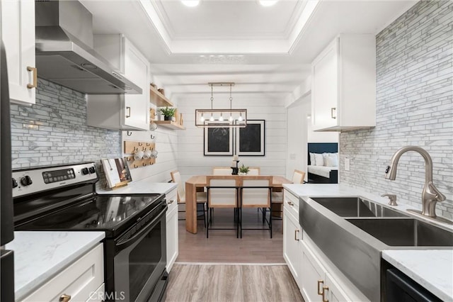 20702 El Toro Rd Unit 300, Lake Forest, CA 92630 - kitchen featuring stainless steel range with electric stovetop, wall chimney exhaust hood, a raised ceiling, a sink, and backsplash