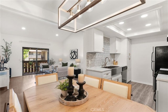 20702 El Toro Rd Unit 300, Lake Forest, CA 92630 - dining area featuring wood finished floors, recessed lighting, a tray ceiling, and baseboards