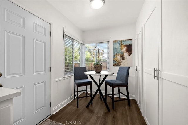 196 Coral View St, Monterey Park, CA 91755 - dining area featuring dark wood finished floors, a decorative wall, and wainscoting