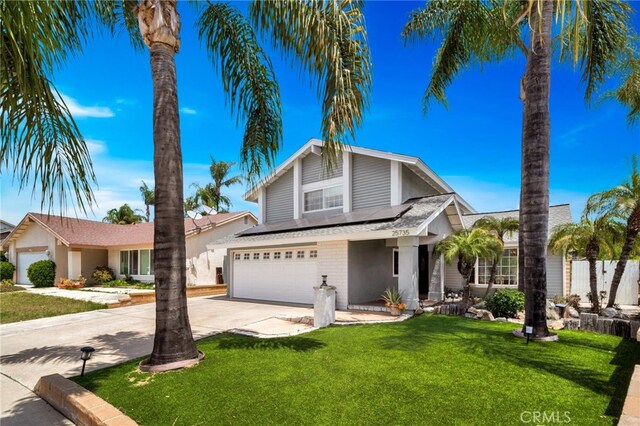 25735 Williamsburg Ct, Lake Forest, CA 92630 - traditional home with roof mounted solar panels, an attached garage, driveway, and a front yard