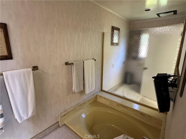 bathroom with a garden tub, crown molding, and a shower