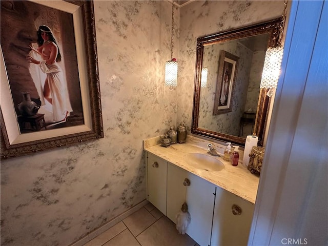 bathroom with tile patterned floors, vanity, wallpapered walls, and baseboards