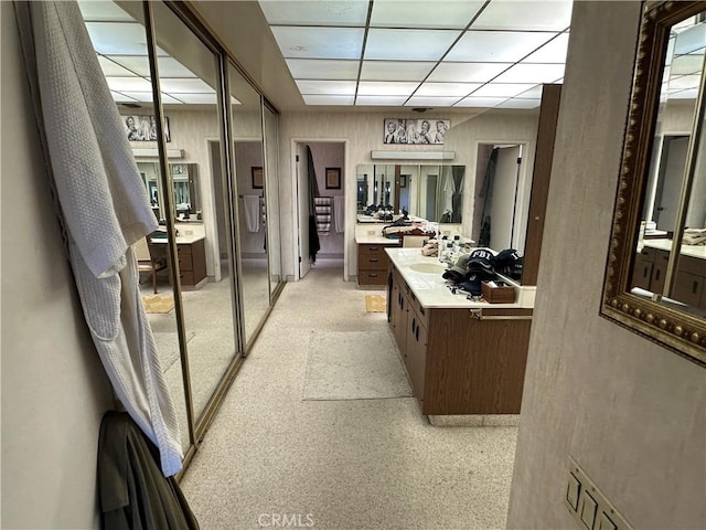 bathroom with a drop ceiling and vanity