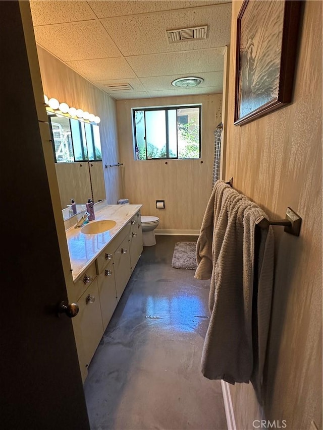 full bath with toilet, vanity, wood walls, and curtained shower