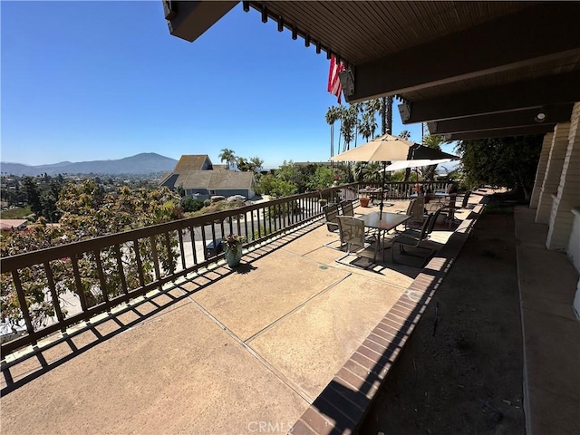 view of patio with a mountain view and outdoor dining area