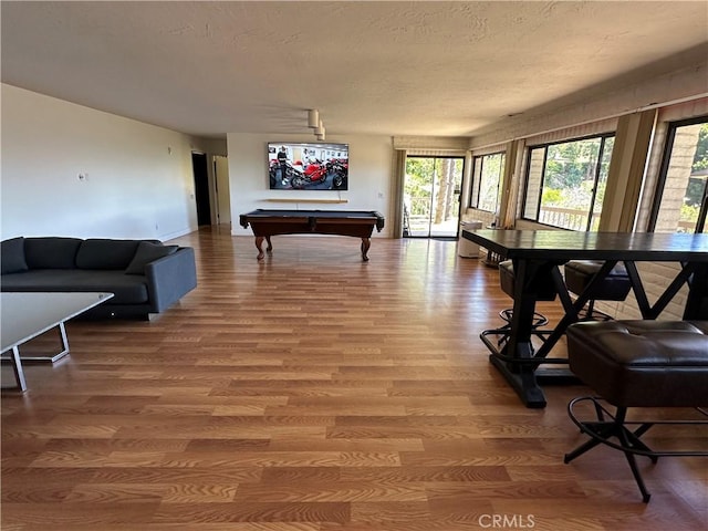 playroom with billiards, light wood-style flooring, and a textured ceiling