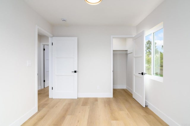 5157 Trinidad Way, San Diego, CA 92114 - unfurnished bedroom featuring light wood finished floors, baseboards, a closet, and a walk in closet