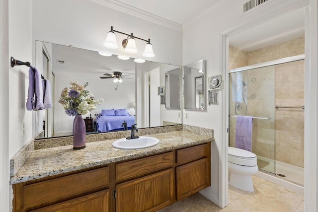 ensuite bathroom featuring ceiling fan, a stall shower, toilet, vanity, and ornamental molding