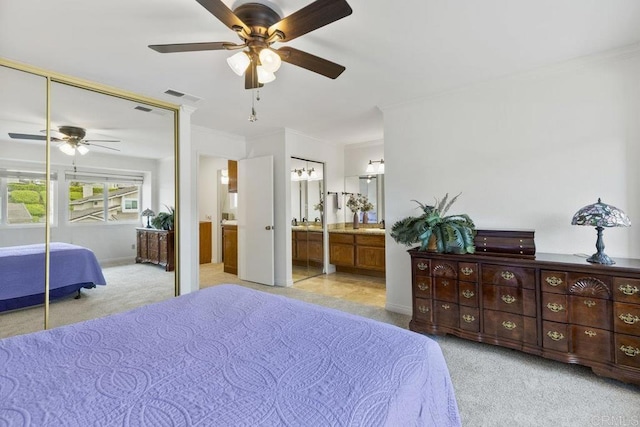 bedroom with light carpet, a closet, ornamental molding, and a ceiling fan
